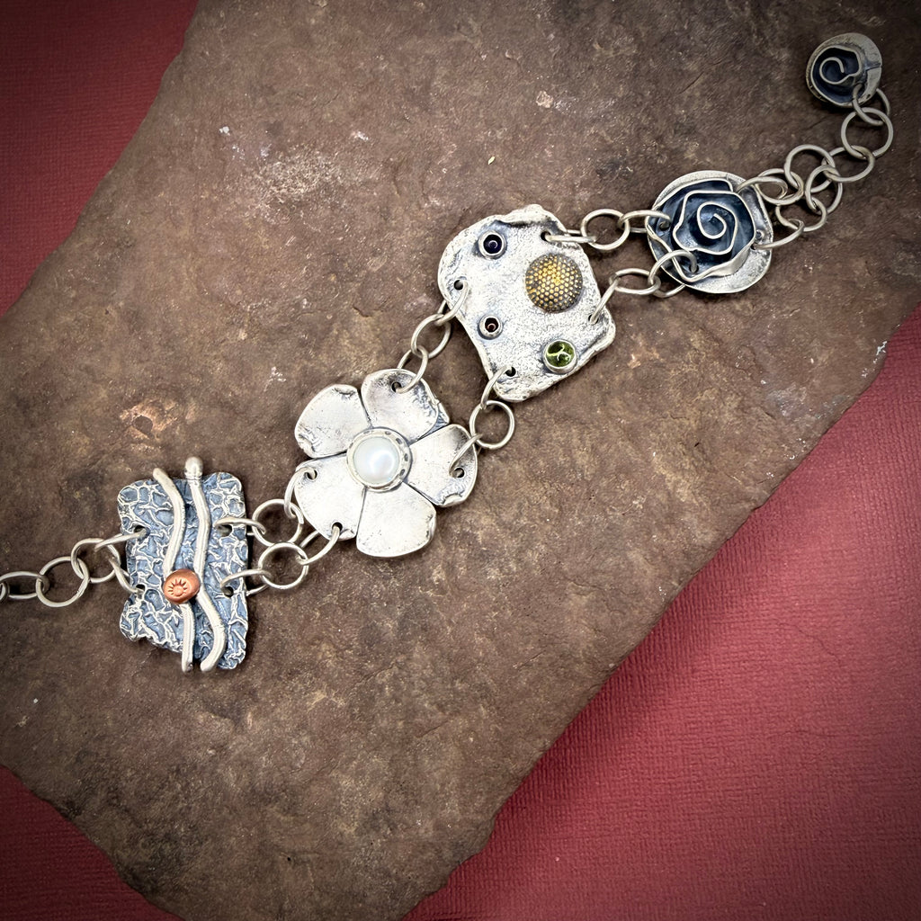 Large element bracelet with pearl, peridot, amber, and amethyst.