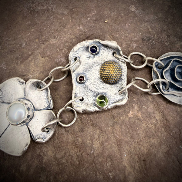 Large element bracelet with pearl, peridot, amber, and amethyst.