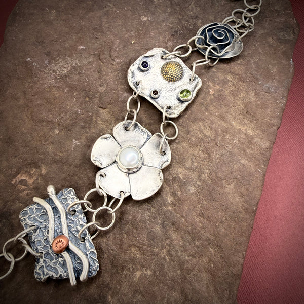 Large element bracelet with pearl, peridot, amber, and amethyst.